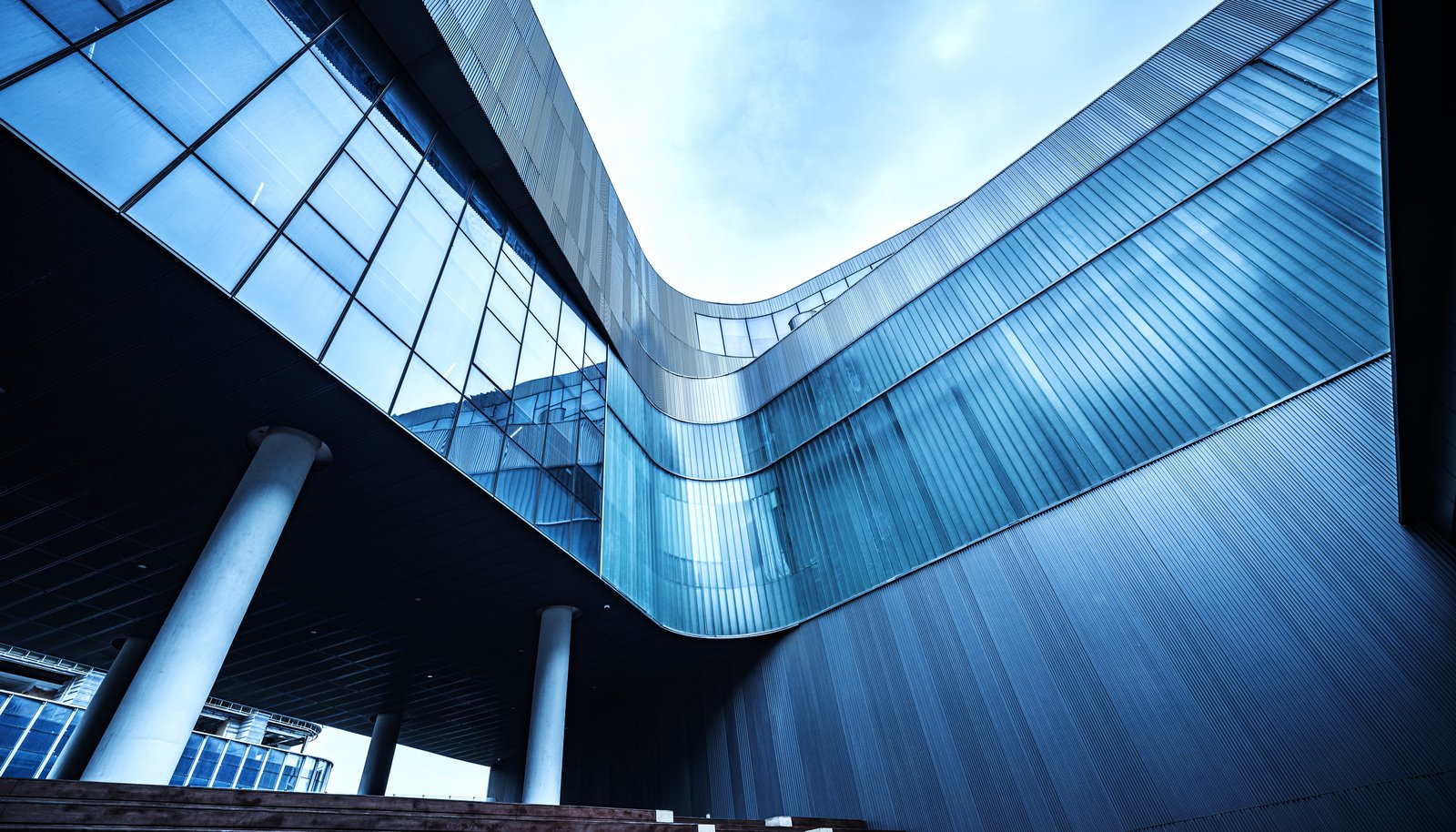 Modern curved glass architecture, representing enterprise systems built to last