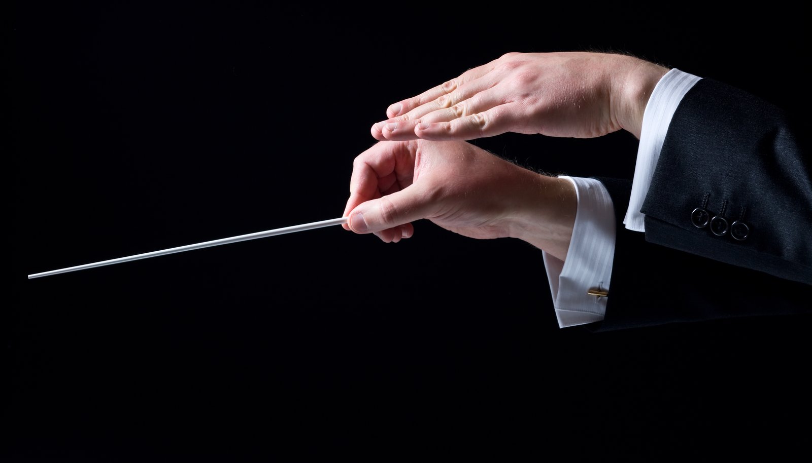 A conductor's hands directing with a baton, representing AI orchestrating Marketing Cloud